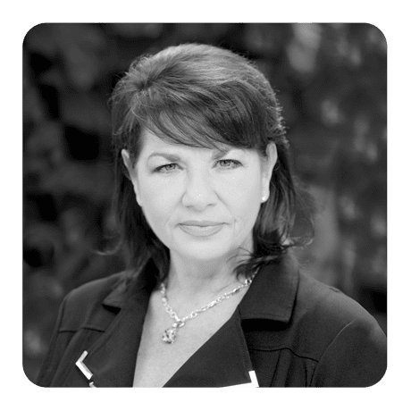 A black and white photo of a woman in a suit.