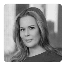 Woman in grayscale portrait, city background.